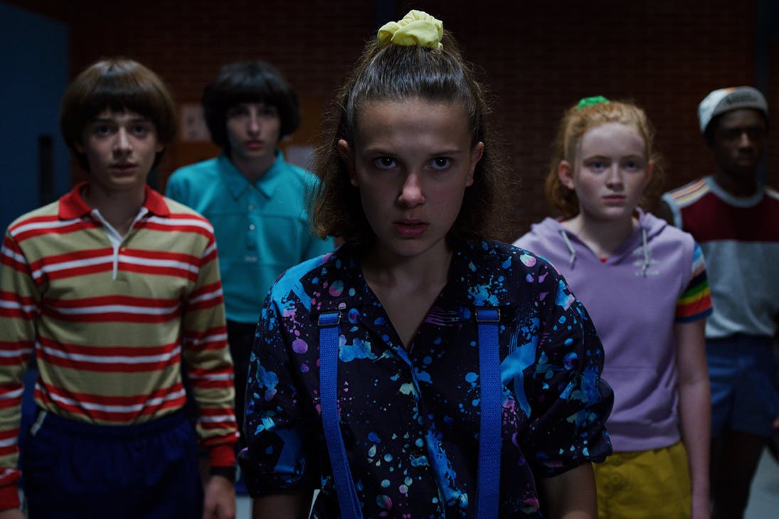 a group of teens gather in a group at night.